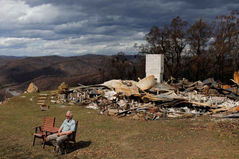 Donald Graham, 68, sits to be interviewed by Reuters beside his home which was destroyed by bushfires in Buchan, Victoria, Australia
