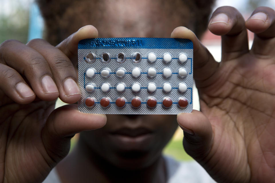 A woman holds a packet of contraceptive pills, in Harare, Thursday, April 9, 2020. Lockdowns imposed to curb the coronavirus’ spread have put millions of women in Africa, Asia and elsewhere out of reach of birth control and other sexual and reproductive health needs. Confined to their homes with husbands and others, they face unwanted pregnancies and little idea of when they can reach the outside world again. (AP Photo/Tsvangirayi Mukwazhi)