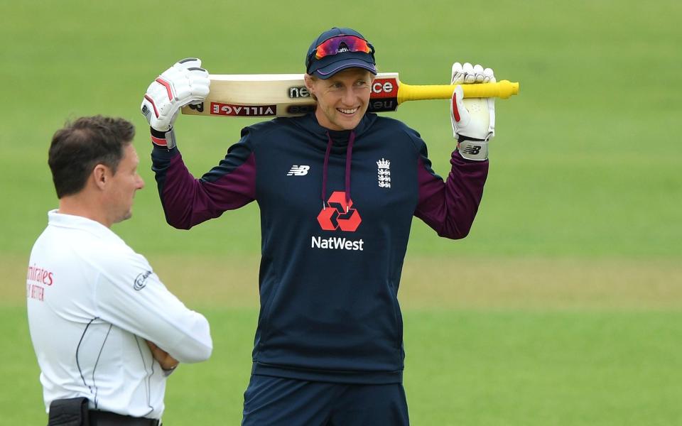 Joe Root talks to umpire Richard Kettleborough during day one of a warm-up match at the Ageas Bowl - AP