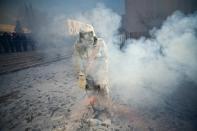 IBI, SPAIN - DECEMBER 28: A Reveler takes part in the battle of 'Enfarinats', a flour fight in celebration of the Els Enfarinats festival on December 28, 2012 in Ibi, Spain. Citizens of Ibi annually celebrate the festival with a battle using flour, eggs and firecrackers. The battle takes place between two groups, a group of married men called 'Els Enfarinats' which take the control of the village for one day pronouncing a whole of ridiculous laws and fining the citizens that infringe them and a group called 'La Oposicio' which try to restore order. At the end of the day the money collected from the fines is donated to charitable causes in the village. The festival has been celebrated since 1981 after the town of Ibi recovered the tradition but the origins remain unknown. (Photo by David Ramos/Getty Images)