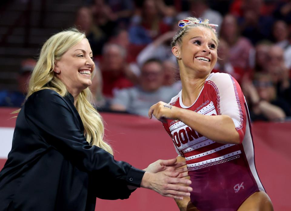 OU coach K.J. Kindler celebrates with Ragan Smith after she competed in the beam during a meet on Feb. 9 at Lloyd Noble Center in in Norman.