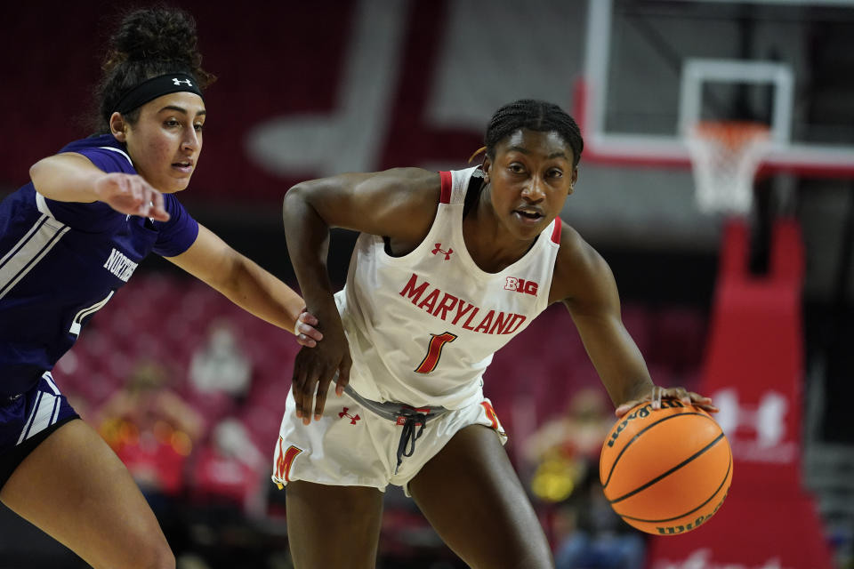 Maryland guard Diamond Miller, right, drives against Northwestern guard Jillian Brown during the second half of an NCAA college basketball game, Sunday, Jan. 23, 2022, in College Park, Md. Maryland won 87-59. (AP Photo/Julio Cortez)