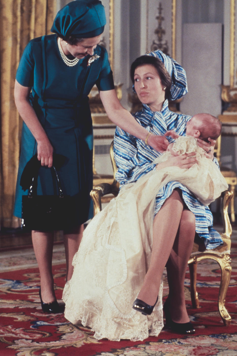 Queen Elizabeth II with her daughter, Princess Anne and grandson, Peter Phillips at the baby boy's christening, 12th December 1977.