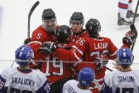 Canada's Aaron Ekblad (5), Nic Petan (19), Sam Reinhart and Curtis Lazar (26) celebrate Petan's empty net goal against Slovakia during the third period of their IIHF World Junior Championship ice hockey game in Malmo, Sweden, December 30, 2013. REUTERS/Alexander Demianchuk (SWEDEN - Tags: SPORT ICE HOCKEY)