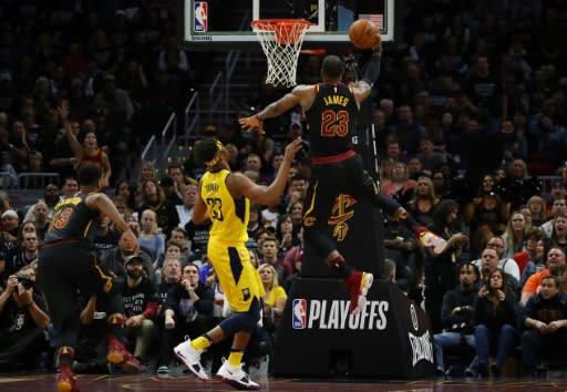 LeBron James of the Cleveland Cavaliers (R) drives around Myles Turner of the Indiana Pacers