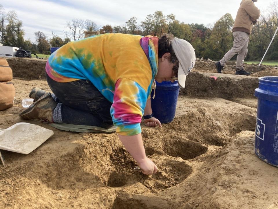 Archeologist Samantha Muscella used a tablespoon to excavate a post hole at the site of Camp Security.