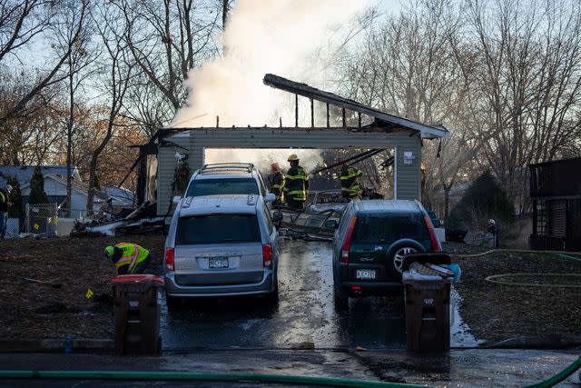 <p>Leila Navidi/Star Tribune via AP</p> Fire crews work to put out a fire after a home exploded, Thursday, Nov. 30, 2023, in South St. Paul, Minn.