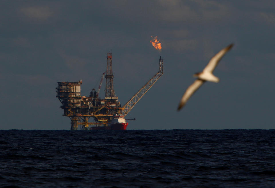 A seagull flies in front of an oil platform in the  Bouri Oilfield some 70 nautical miles north of the coast of Libya, October 5, 2017.   REUTERS/Darrin Zammit Lupi