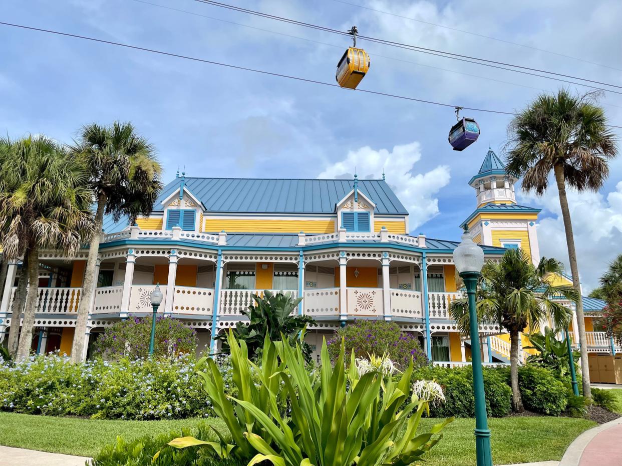 external shot of the skyliner riding past the caribbean beach resort disney world