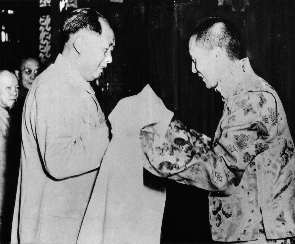 The Dalai Lama giving a white silk scarf to the Chinese President Mao Zedong in Beijing, 1954.