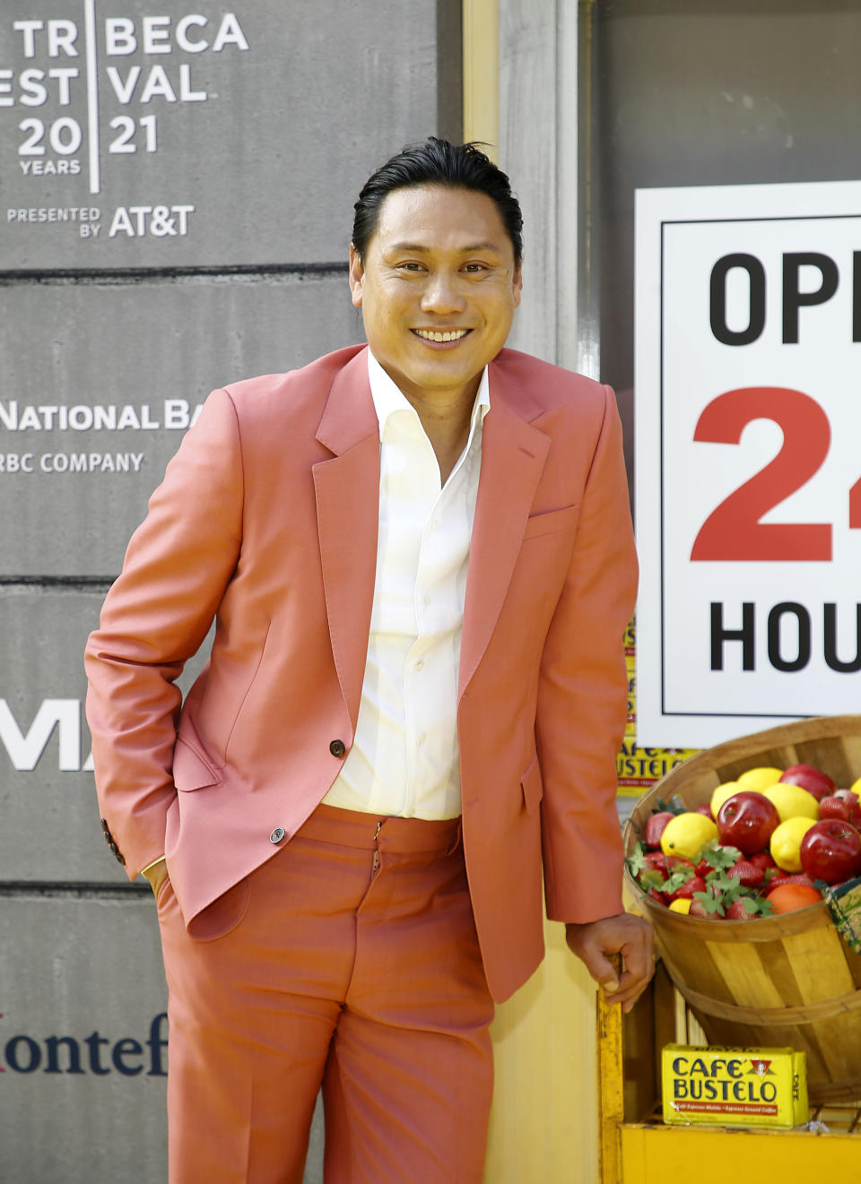 jon m. chu poses on a red carpet