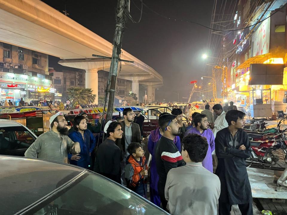 People come out of a restaurant after a tremor was felt in Lahore, Pakistan on 21 March, 2023 (REUTERS)
