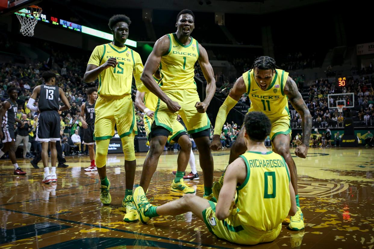 Oregon’s Lök Wur, N'Faly Dante and Rivaldo Soares celebrate after teammate Will Richardson was fouled in the second half as the Oregon Ducks host the Washington State Cougars to open Pac-12 play Thursday, Dec. 1, 2022, at Matthew Knight Arena in Eugene, Ore.