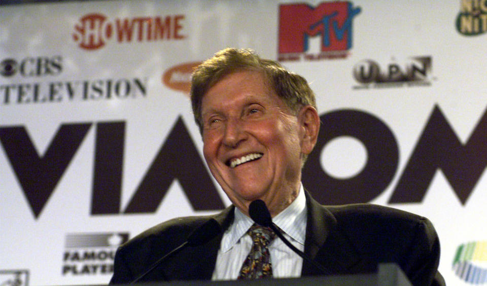 FILE - In this Sept. 7, 1999 file photo, Viacom Chairman Sumner Redstone smiles during the announcement of a merger between CBS and Viacom in New York. Redstone, the strong-willed media mogul whose public disputes with family members and subordinates made him a feared operator in Hollywood, died Wednesday, Aug. 12, 2020. (AP Photo/Suzanne Plunkett)