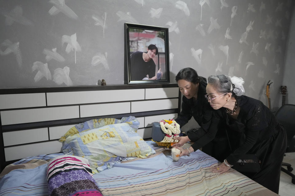 Family members of Duangphet Phromthep bring his ashes to his bedroom in Chiang Rai province Thailand, Saturday, March 4, 2023. The cremated ashes of Duangphet, one of the 12 boys rescued from a flooded cave in 2018, arrived in the far northern Thai province of Chiang Rai on Saturday where final Buddhist rites for his funeral will be held over the next few days following his death in the U.K. (AP Photo/Sakchai Lalit)