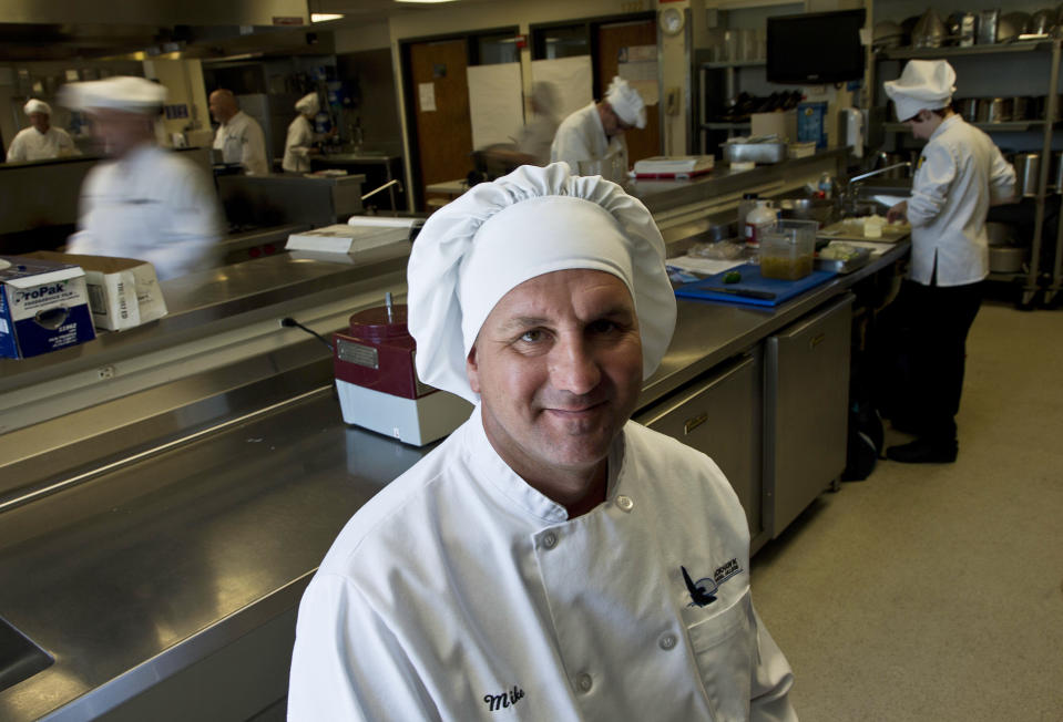 This Thursday, May 10, 2012 photo shows Mike Szlamczynski at the Blackhawk Tech College in Janesville, Wis. After 15 years on the Chrysler line, the autoworker took a buyout, returned to college at age 41 and studied to be a chef. He wanted financial security, no more layoffs, no more fears of losing it all. "I was tired of worrying," he says. "I had nothing to fall back on. If you have an education, that's something they can't take away from you. You have options. Before, I didn't have any options." On May 12, 2012, the man who dropped out of school 20 years ago after concentrating on fun more than work graduated from Blackhawk Technical College with an associate's degree in culinary arts and a 3.8 average _ "a huge accomplishment," he says. Most importantly, he left with a coveted commodity: a job as a cook at a casino-resort in New York state. (AP Photo/Morry Gash)