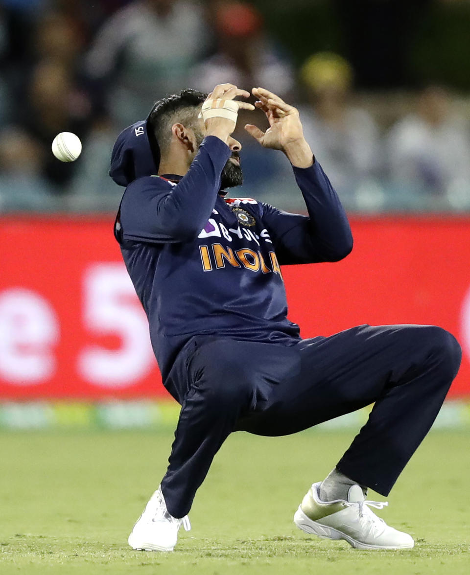 India's Virat Kohli drops a catching chance while fielding against Australia during their T20 international cricket match at Manuka Oval, in Canberra, Australia, Friday, Dec 4, 2020. (AP Photo/Mark Baker)