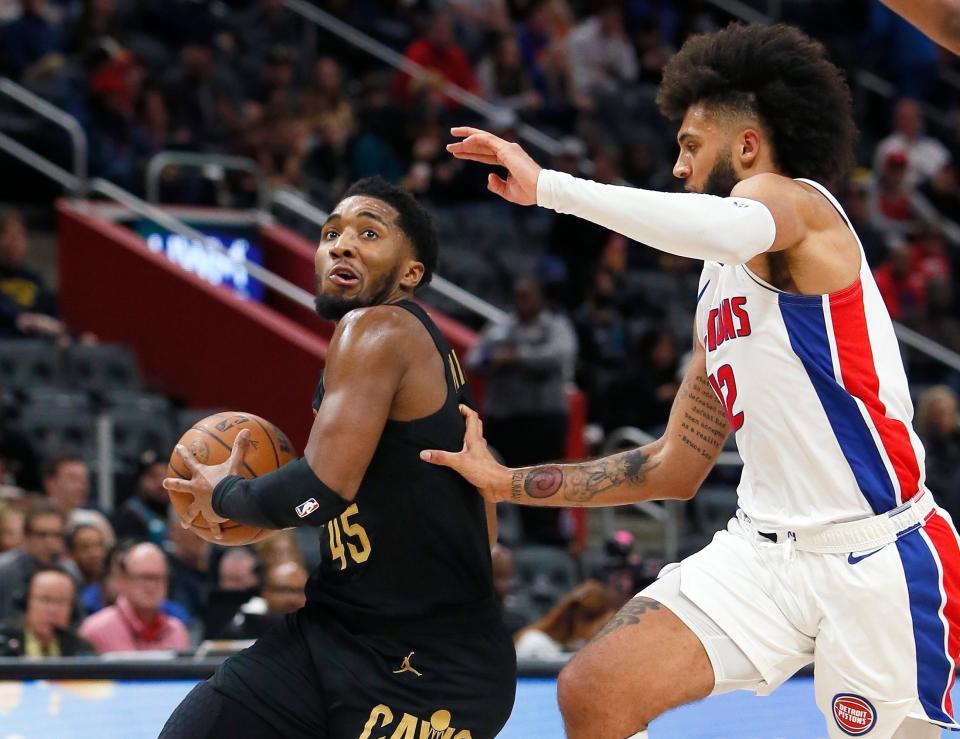 Cavaliers guard Donovan Mitchell drives to the basket against Pistons forward Isaiah Livers during the second half Sunday, Nov. 27, 2022, in Detroit. The Cavaliers won 102-94.