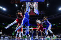 Atlanta Hawks' Clint Capela (15) blocks a shot by Philadelphia 76ers' Joel Embiid (21) during the first half of an NBA basketball game, Saturday, Oct. 30, 2021, in Philadelphia. (AP Photo/Matt Slocum)