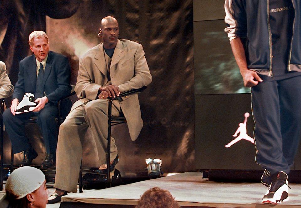 <span class="caption">Michael Jordan watches a model showcase apparel from Jordan’s clothing line at New York City’s NikeTown in 1997.</span> <span class="attribution"><a class="link " href="http://www.apimages.com/metadata/Index/Associated-Press-Finance-amp-Business-New-Yor-/fd63813a3ae5da11af9f0014c2589dfb/15/0" rel="nofollow noopener" target="_blank" data-ylk="slk:AP Photo/Kathy Willens;elm:context_link;itc:0;sec:content-canvas">AP Photo/Kathy Willens</a></span>