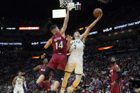 Milwaukee Bucks guard Grayson Allen (7) goes to the basket as Miami Heat guard Tyler Herro (14) defends during the first half of an NBA basketball game Thursday, Oct. 21, 2021, in Miami. (AP Photo/Lynne Sladky)