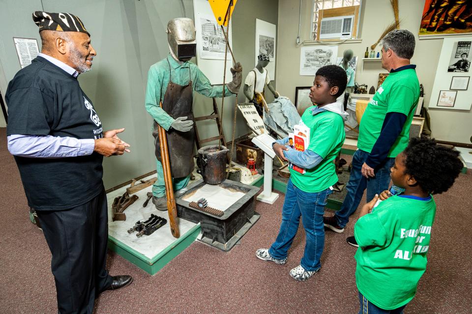 Clayborn Benson, Executive Director of the Wisconsin Black Historical Society and Museum, speaks with 6-year-old Alayah Tyson, 10-year-old Andreyis Tyson, and Henry Tyson of Milwaukee about the presence and contributions of African Americans particularly in Wisconsin's workforce on Saturday April 29, 2023 at the Wisconsin Black Historical Society and Museum in Milwaukee, Wis. Jovanny Hernandez / Milwaukee Journal Sentinel