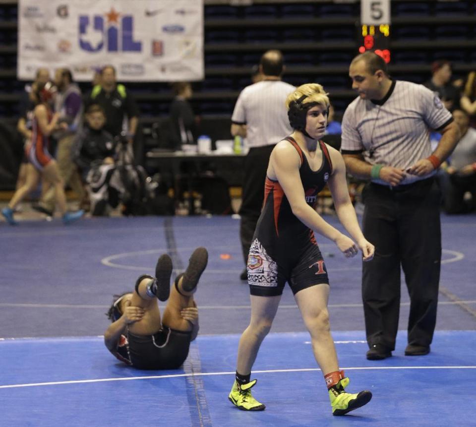 Mack Beggs, right, a transgender wrestler from Euless Trinity, is shown during a quarterfinal against Mya Engert of Amarillo Tascosa during the state wrestling tournament Friday, Feb. 24, 2017, in Cypress, Texas. Beggs was born a female and is transitioning to male but wrestles in the girls division. (Melissa Phillip/Houston Chronicle via AP)