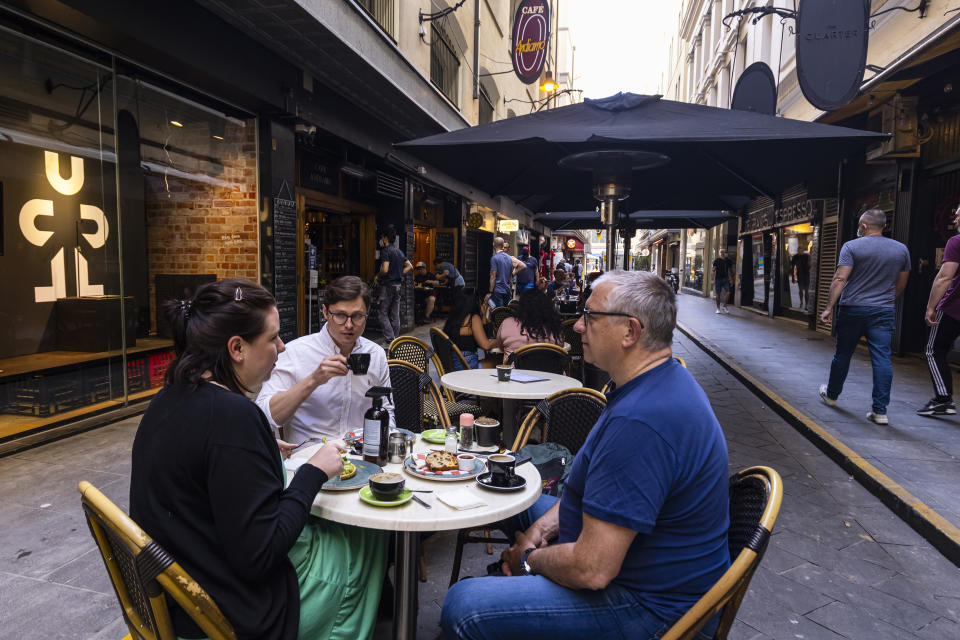 People dine outdoors in Degraves Street in Melbourne, Friday, Oct. 22, 2021. Melbourne, Australia’s most populous city after Sydney, came out of 77 days of lockdown on Friday after Victoria state reached a benchmark of 70% of the target population fully vaccinated. (Daniel Pockett/AAP Image via AP)