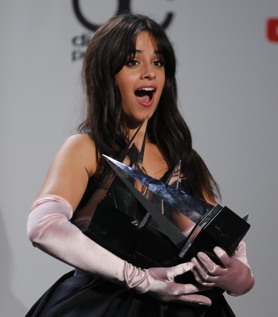 2018 American Music Awards - Photo Room - Los Angeles, California, U.S., 09/10/2018 - Camila Cabello poses backstage with her awards. REUTERS/Mike Blake