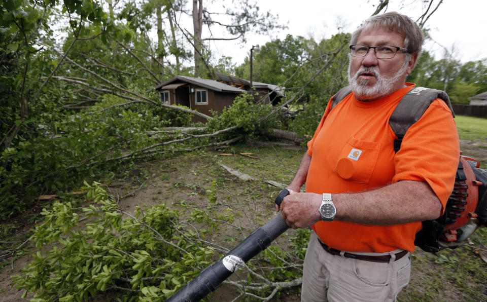 David Poole of Flora, Miss., recalls seeing the falling debris from Saturday's storm as he begins clean up Sunday, April 14, 2019. Poole, 63, said he spent much of the evening outside his home with a broom, sweeping away flash flood waters from the intense rain. The storm was one of several that hit the state. (AP Photo/Rogelio V. Solis)