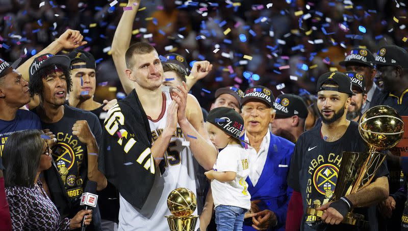 Denver Nuggets center Nikola Jokic, center left, celebrates with teammates after the team won the NBA Championship with a victory over the Miami Heat in Game 5 of basketball’s NBA Finals, Monday, June 12, 2023, in Denver. 