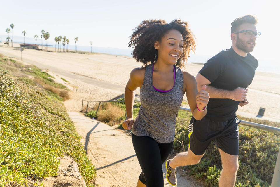 Man and woman running. (Getty Images)