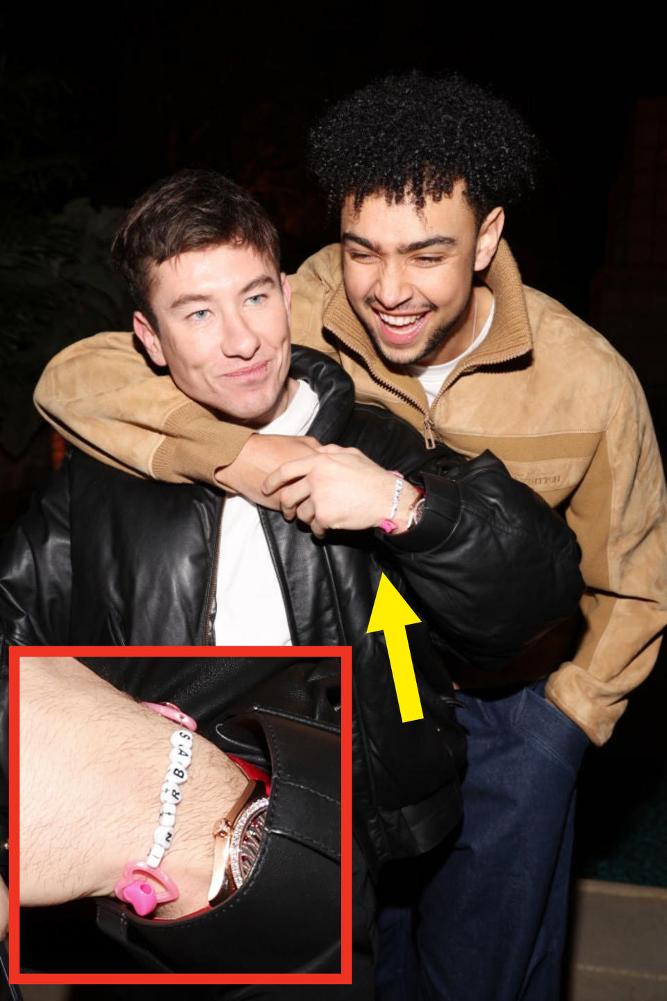 The two men smiling and embracing, the bracelet shown on barry's wrist