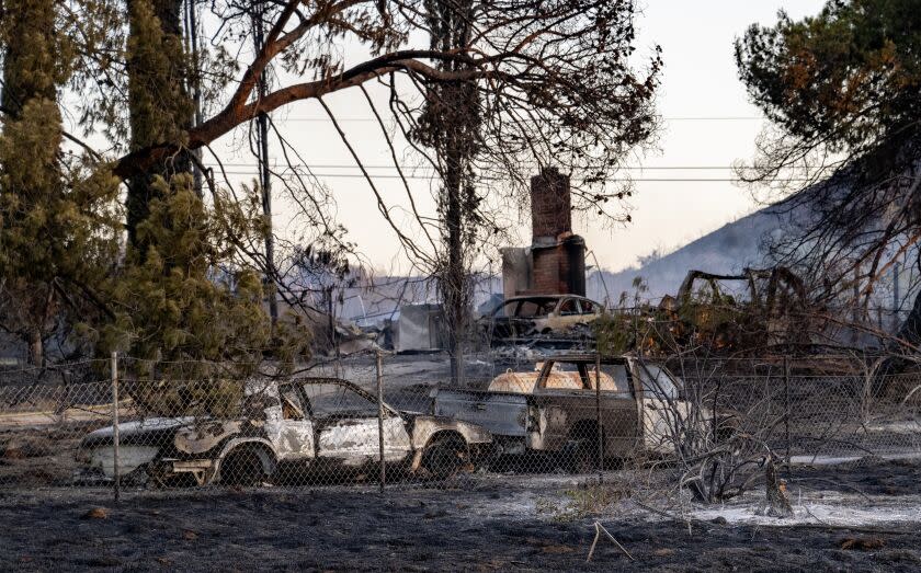 PERRIS, CA - JUNE 27, 2023: Multiple cars and a home are destroyed after the Juniper fire burned along Santa Rosa Mine Road on June 27, 2023 in Perris, California.The Riverside County fire prompted evacuation orders and threatened multiple structures. (Gina Ferazzi / Los Angeles Times)