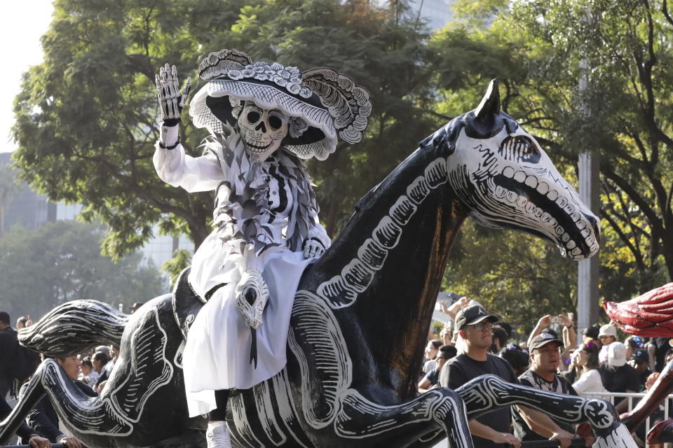A participant takes part in a James Bond-inspired Day of the Dead Parade, in Mexico City, Saturday, Nov. 4, 2023. The Hollywood-style parade was adopted in 2016 by Mexico City to mimic a fictitious march in the 2015 James Bond movie “Spectre.” (AP Photo/Ginnette Riquelme)
