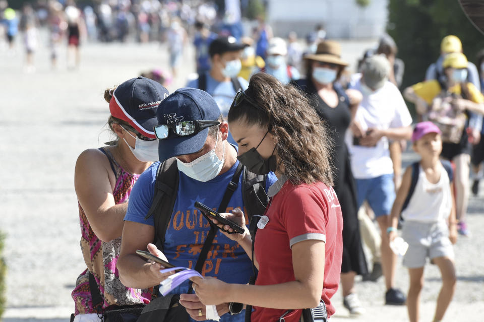 An employee checks a visitor's health pass at the entrance of the Puy du Fou theme park in Les Epesses, western France, July 21, 2021. / Credit: SEBASTIEN SALOM-GOMIS/AFP/Getty