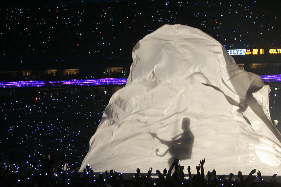 the shadow of prince holding his guitar