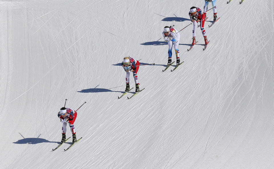 Norway's Marit Bjoergen, Norway's Therese Johaug, Sweden's Charlotte Kalla and Norway's Heidi Weng, from left, ski down a hill during the women's 15k skiathlon at the 2014 Winter Olympics, Saturday, Feb. 8, 2014, in Krasnaya Polyana, Russia. (AP Photo/Dmitry Lovetsky)