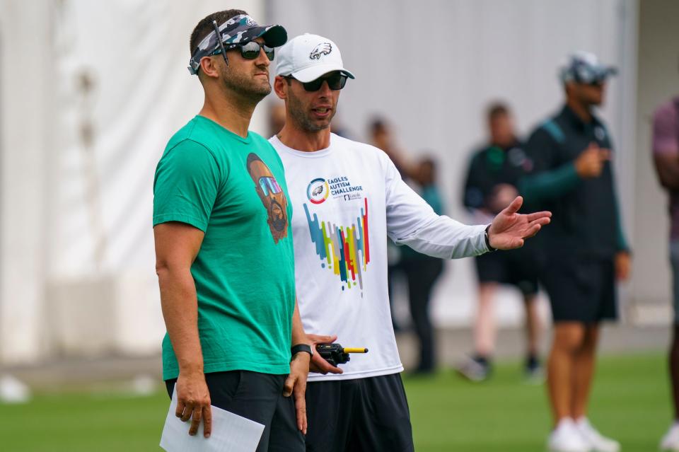 Philadelphia Eagles head coach Nick Sirianni (left) listens to defensive coordinator Jonathan Gannon (right) during the NFL football team's training camp on July 27, 2022, in Philadelphia.