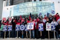 Striking United Auto Workers (UAW) members rally in front of General Motors World headquarters in Detroit