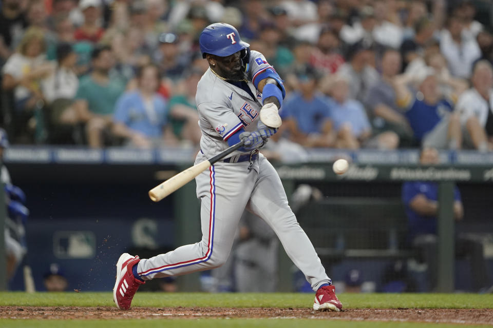 Texas Rangers' Adolis Garcia hits a double during the seventh inning of a baseball game against the Seattle Mariners, Tuesday, July 26, 2022, in Seattle. (AP Photo/Ted S. Warren)