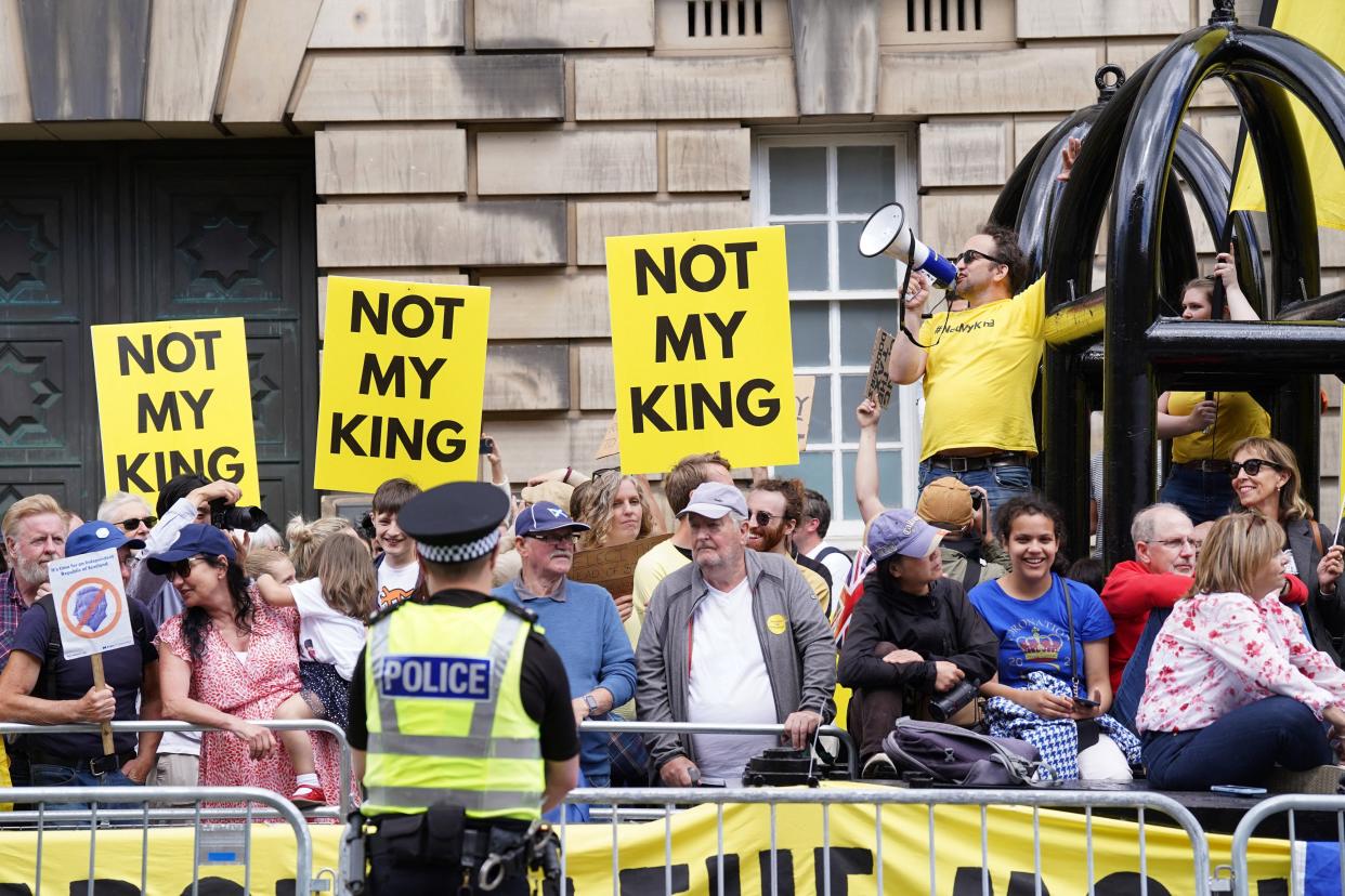 Protesters hold signs titles ‘Not my King’ (AFP via Getty)