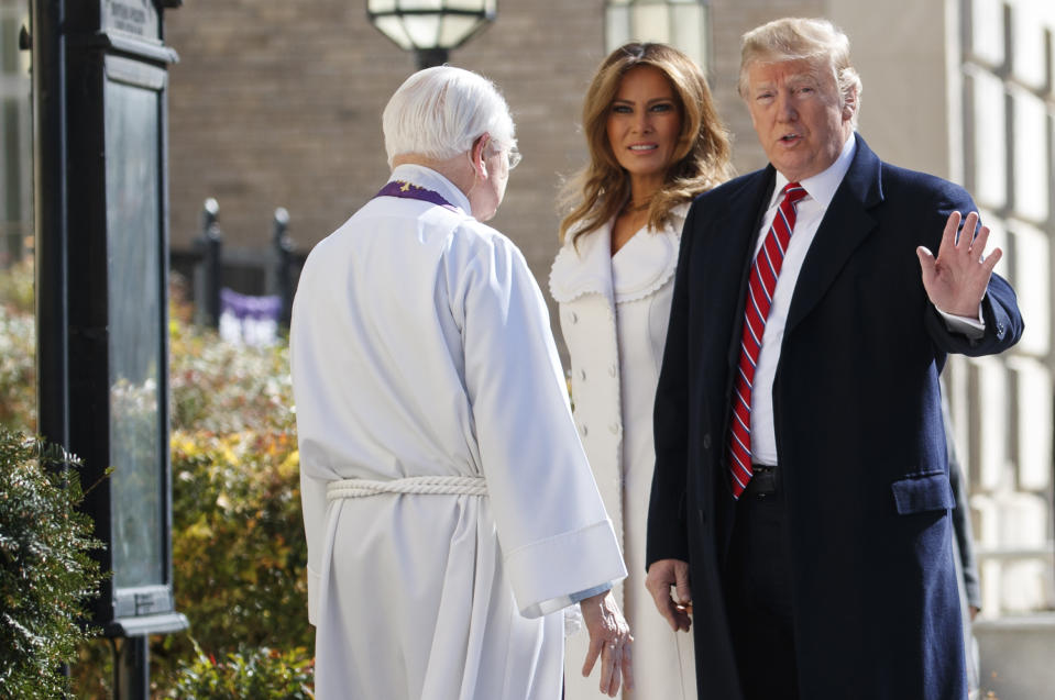 President Donald Trump, with first lady Melania Trump and Reverend Bruce McPherson, waves to media as they arrive to attend service at Saint John's Church in Washington, Sunday, March 17, 2019 (AP Photo/Carolyn Kaster)