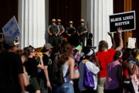 <p>Members of National Park Service watch as protesters pass the Old Courthouse after the not guilty verdict was announced in the murder trial of Jason Stockley, a former St. Louis police officer, charged with the 2011 shooting of Anthony Lamar Smith, in St. Louis, Mo., Sept. 15, 2017. (Photo: Whitney Curtis/Reuters) </p>
