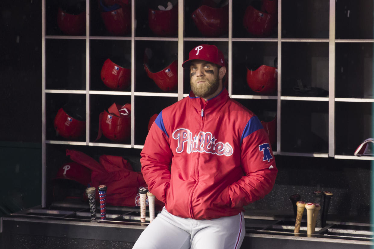 Philadelphia Phillies' Bryce Harper watches a video tribute in honor of him from the dugout before a baseball game against the Washington Nationals at Nationals Park, Tuesday, April 2, 2019, in Washington. (AP Photo/Alex Brandon)