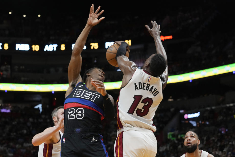Miami Heat center Bam Adebayo (13) blocks a shot to the basket by Detroit Pistons guard Jaden Ivey (23) during the first half of an NBA basketball game, Wednesday, Oct. 25, 2023, in Miami. (AP Photo/Marta Lavandier)