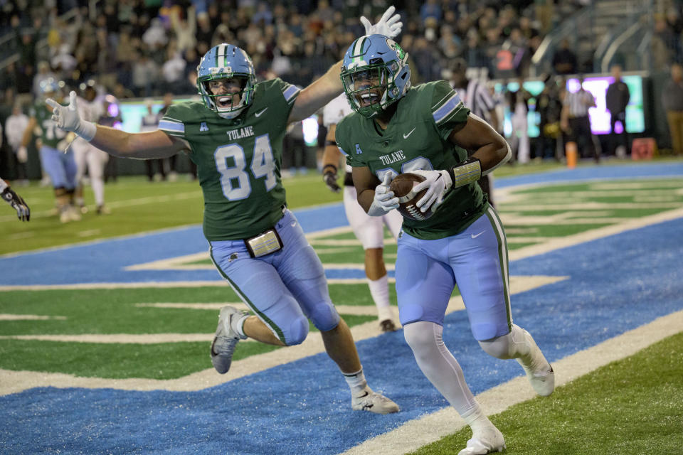 Tulane tight end Reggie Brown celebrates a touchdown against UCF with Tulane tight end Will Wallace (84) during the second half of an NCAA college football game in New Orleans, Saturday, Nov. 12, 2022. (AP Photo/Matthew Hinton)