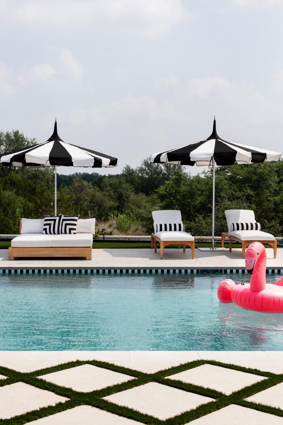 pool with black-and-white tile and umbrella