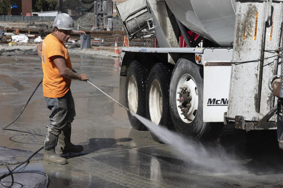 A worker cleans a cement truck at a construction site, Friday, Sep. 1, 2023, in Boston. On Friday, the U.S. government issues its latest monthly jobs report. (AP Photo/Michael Dwyer)