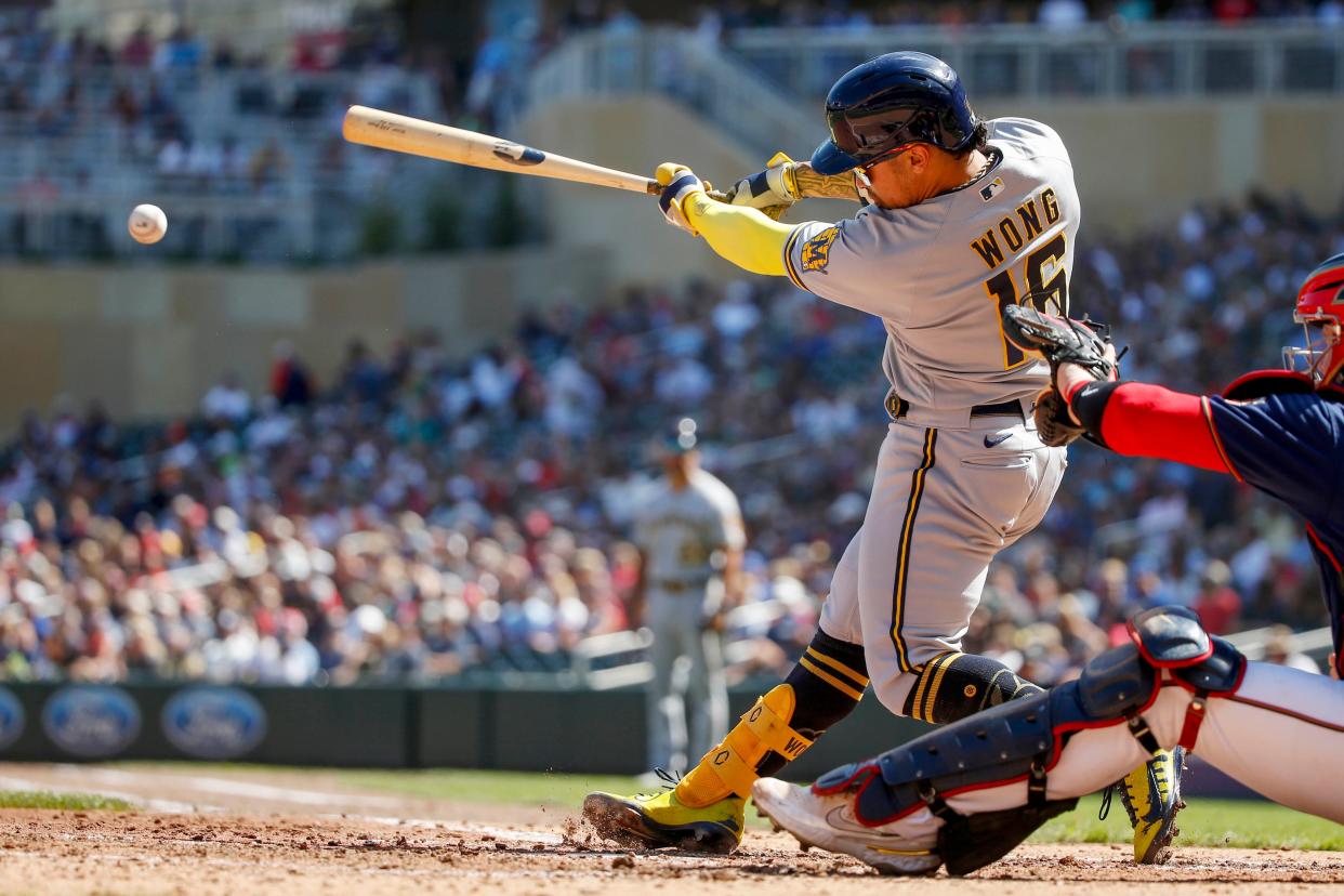 Milwaukee Brewers second baseman Kolten Wong (16) hits a two run double in the fourth inning at Target Field on April 29, 2021.